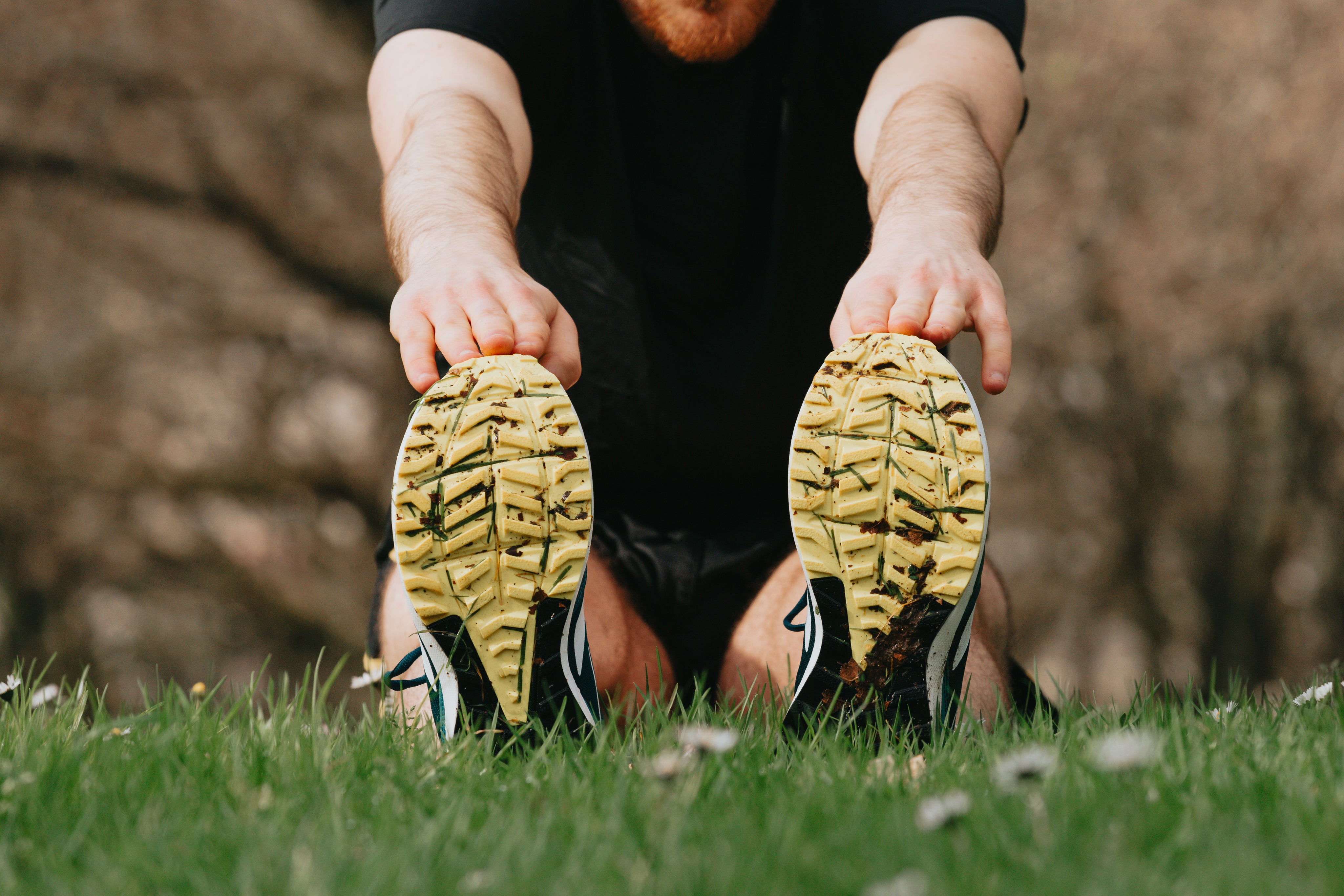 running-shoes-on-green-grass-of-a-person-stretching.jpg